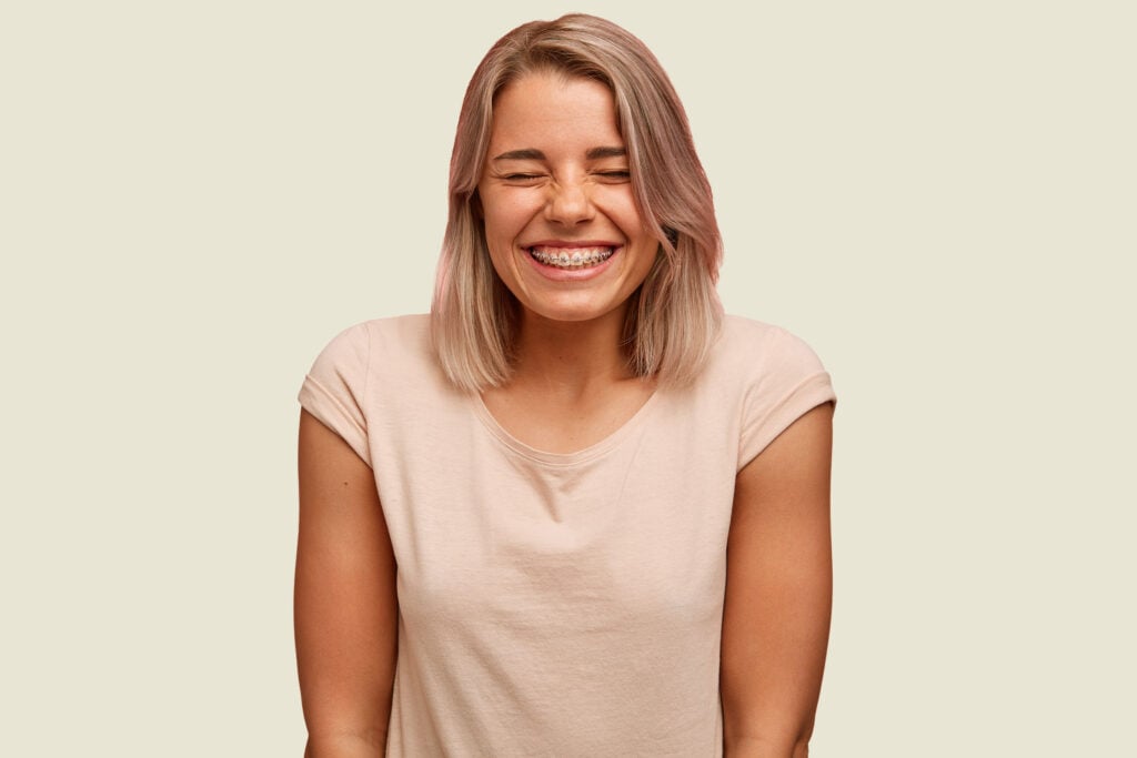 A smiling young woman with braces